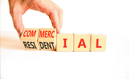 Commercial or residential symbol. Concept words Commercial or Residential on beautiful wooden blocks. Beautiful white background. Business commercial or residential concept. Copy space.の写真素材