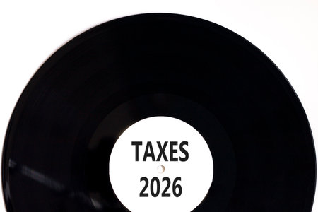 Taxes 2026 new year symbol. Concept words Taxes 2026 on beautiful white and black vinyl disk....