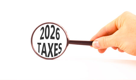 2026 taxes new year symbol. Concept words 2026 taxes on beautiful white paper. Black magnifying...