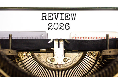 Review 2026 symbol. Concept words Review 2026 typed on beautiful old retro typewriter. Beautiful white paper background. Beautiful old typewriter. Business and review 2026 concept. Copy space.の写真素材