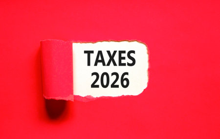 Taxes 2026 new year symbol. Concept words Taxes 2026 on beautiful white paper. Beautiful red paper...