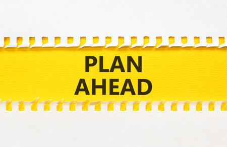 Plan ahead symbol. Concept word Plan ahead on beautiful white paper. Beautiful yellow paper background. Business plan ahead concept. Copy space.の写真素材