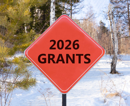 2026 Grants symbol. Concept words 2026 Grants on beautiful red road sign. Beautiful winter forest...