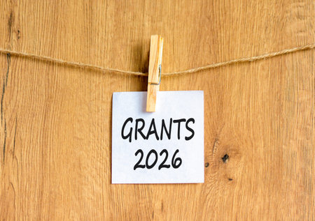 Grants 2026 symbol. Concept words Grants 2026 on beautiful white paper on wooden clothespin....