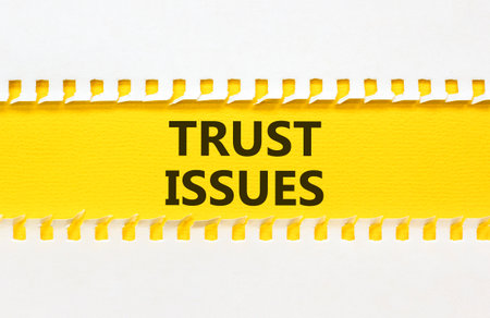 Trust issues symbol. Concept word Trust issues on beautiful white paper. Beautiful yellow paper...
