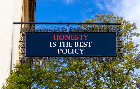 Honesty is the best policy. Concept words Honesty is the best policy on black beautiful road sign. Beautiful blue sky trees background. Business honesty is the best policy concept. Copy space.の写真素材