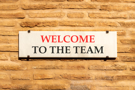 Support, help welcome to the team symbol. Concept words Welcome to the team on beautiful white marble sign plate. Beautiful brick wall background. Business welcome to the team concept. Copy space.の写真素材