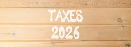 Taxes 2026 new year symbol. Concept words Taxes 2026 on beautiful wooden wall. Beautiful wooden wall background. Business and taxes 2026 new year concept. Copy space.の写真素材
