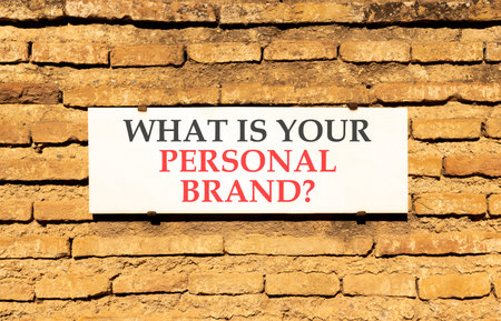 What is your personal brand symbol. Concept words What is your personal brand on white marble sign plate. Beautiful brick wall background. Business what is your personal brand concept. Copy space.の写真素材