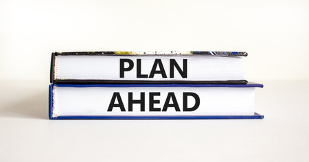 Plan ahead symbol. Concept word Plan ahead on beautiful books. Beautiful white paper background. Business plan ahead concept. Copy space.の写真素材