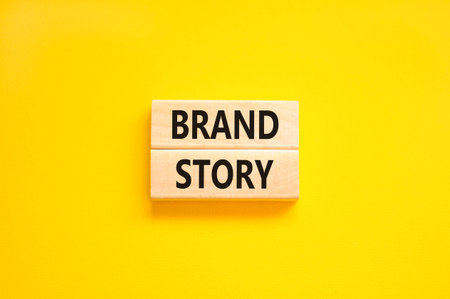 Brand story branding symbol. Concept words Brand story on beautiful wooden blocks. Beautiful yellow background. Business brand story branding concept. Copy space.の写真素材