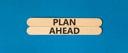 Plan ahead symbol. Concept word Plan ahead on beautiful wooden sticks. Beautiful blue paper background. Business plan ahead concept. Copy space.の写真素材
