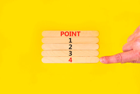 Time to point 4 symbol. Concept word Point 1 2 3 4 on beautiful wooden sticks. Businessman's hand. Beautiful yellow background. Business planning and time to point 4 concept. Copy space.の写真素材