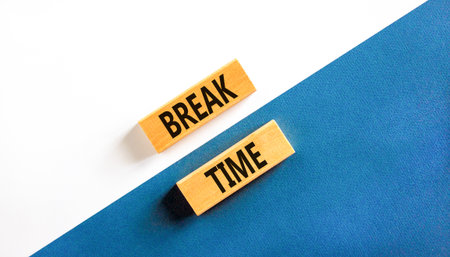 Break time symbol. Concept Break word time on beautiful wooden blocks. Beautiful white and blue paper background. Business break time concept. Copy space.の写真素材