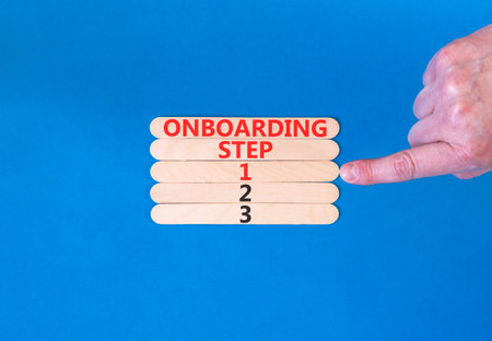 Time to step 1 onboarding symbol. Concept words Onboarding step 1 on beautiful wooden block. Businessman's hand. Beautiful blue background. Business success step 1 onboarding concept. Copy space.の写真素材