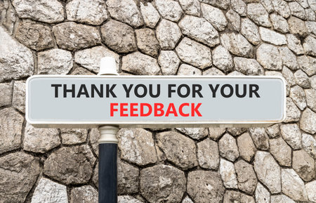 Thank you for your feedback symbol. Concept words Thank you for your feedback on gray beautiful road sign. Beautiful stone wall background. Business thank you for your feedback concept. Copy space.の写真素材
