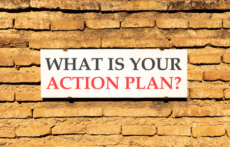 What is your action plan symbol. Concept words What is your action plan on beautiful white marble sign plate. Beautiful brick wall background. Business what is your action plan concept. Copy space.の写真素材