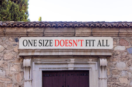 One size does not fit all symbol. Concept words One size does not fit all on beautiful white marble sign plate. Beautiful stone wall background. Business one size does not fit all concept. Copy space.の写真素材