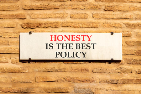 Honesty is the best policy on beautiful white marble sign plate. Beautiful brick wall background. Business honesty is the best policy concept. Copy space.の写真素材