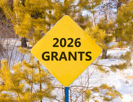 2026 Grants symbol. Concept words 2026 Grants on beautiful yellow road sign. Beautiful winter forest background. Business and 2026 grants concept. Copy space.の写真素材