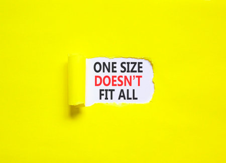 One size does not fit all symbol. Concept words One size does not fit all on beautiful white paper. Beautiful yellow paper background. Business one size does not fit all concept. Copy space.の写真素材