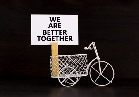 We are better together symbol. Concept words phrase We are better together on beautiful white paper on clothespin. Beautiful black background. Business We are better together concept. Copy space.の写真素材