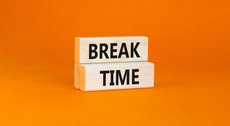 Break time symbol. Concept Break word time on beautiful wooden blocks. Beautiful orange paper background. Business break time concept. Copy space.の写真素材
