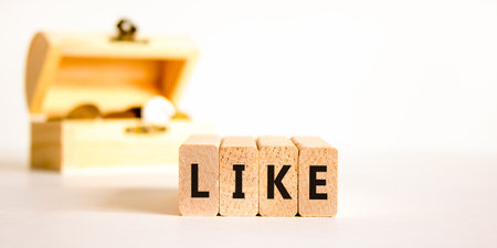 Like symbol. Concept word Like on beautiful wooden blocks. Beautiful wooden chest with coins....