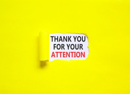 Thank you for your attention symbol. Concept words Thank you for your attention on beautiful white paper. Beautiful yellow paper background. Business thank you for your attention concept. Copy space.の写真素材