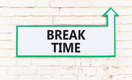 Break time symbol. Concept Break word time on beautiful white sign on white brick wall. Beautiful white brick wall background. Business break time concept. Copy space.の写真素材