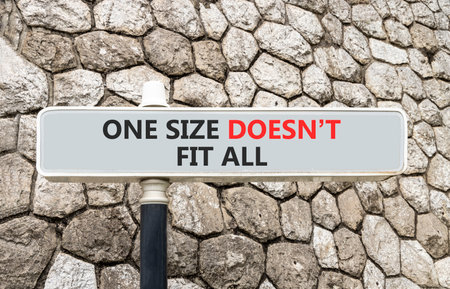 One size does not fit all symbol. Concept words One size does not fit all on gray beautiful road sign. Beautiful stone wall background. Business one size does not fit all concept. Copy space.の写真素材