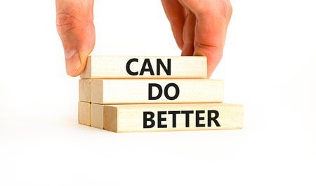 Can do better symbol. Concept words Can do better on beautiful wooden block. Businessman's hand. Beautiful white background. Business and can do better concept. Copy space.の写真素材