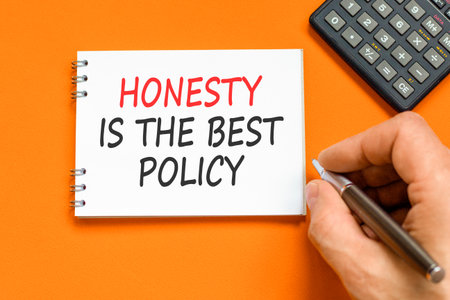 Honesty is the best policy on beautiful note. Beautiful orange background. Businessman's hand. Business honesty is the best policy concept. Copy space.の写真素材