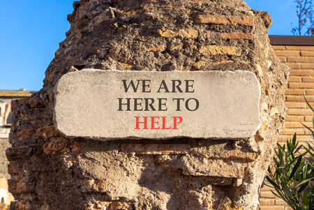 Support, help and we are here to help symbol. Concept words We are here to help on beautiful marble sign plate. Beautiful brick column background. Business we are here to help concept. Copy space.の写真素材