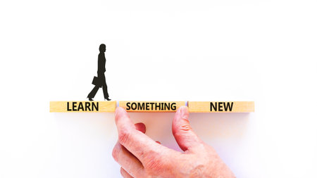 Learn something new symbol. Concept words Learn something new on beautiful block. Businessman's hand. Beautiful white background Business motivational lifestyle learn something new concept Copy spaceの写真素材