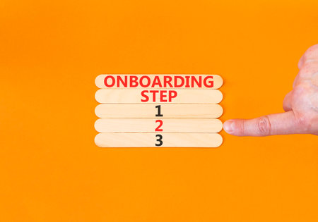 Time to step 2 onboarding symbol. Concept words Onboarding step 2 on beautiful wooden block. Businessman's hand. Beautiful orange background. Business success step 2 onboarding concept. Copy space.の写真素材