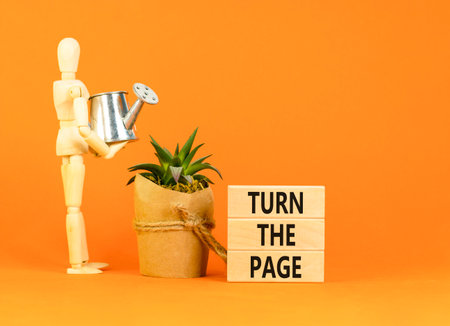 Turn the page symbol. Concept words Turn the page on beautiful wooden block. Businessman model. Beautiful orange background. Business motivational lifestyle turn the page concept. Copy space.の写真素材