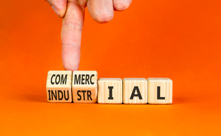 Commercial or industrial symbol. Concept words Commercial or Industrial on beautiful wooden blocks. Beautiful orange background. Business commercial or industrial concept. Copy space.の写真素材