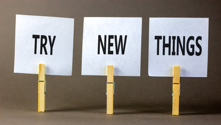 Try new things symbol. Concept words Try new things on beautiful white paper on wooden clothespin. Beautiful gray background. Business motivational lifestyle try new things concept. Copy space.の写真素材