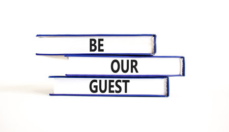 Be our guest symbol. Concept words Be our guest on beautiful books. Beautiful white paper background. Business and be our guest concept. Copy space.の写真素材
