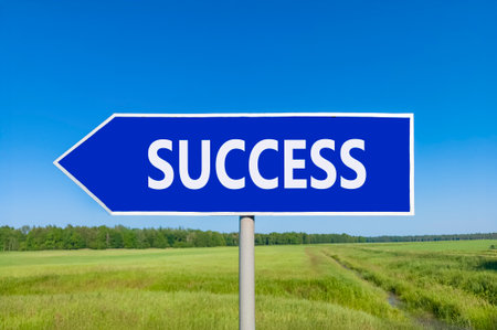 Success symbol. Concept word Success on beautiful blue road sign. Beautiful blue sky green grass and forest peaceful nature background. Business success concept. Copy space.の写真素材
