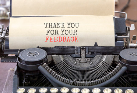Thank you for your feedback symbol. Concept words Thank you for your feedback typed on old retro typewriter. Beautiful white paper background. Business thank you for your feedback concept. Copy space.の写真素材