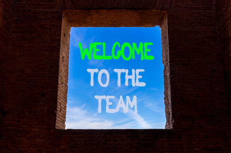 Support, help welcome to the team symbol. Concept words Welcome to the team on beautiful window in ancient brick wall. Beautiful blue sky background. Business welcome to the team concept. Copy space.の写真素材