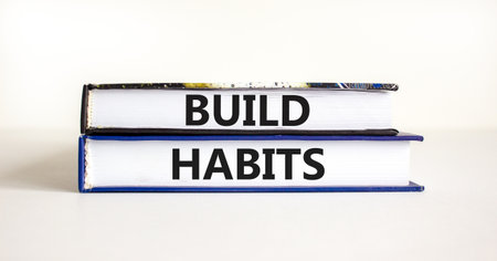 Build habits symbol. Concept word Build habits on beautiful books. Beautiful white paper background....