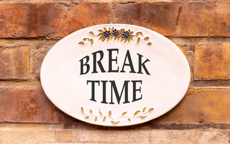 Break time symbol. Concept Break word time on beautiful white sign on brown old brick wall....
