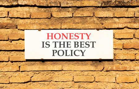 Honesty is the best policy. Concept words Honesty is the best policy on beautiful white marble sign plate. Beautiful brick wall background. Business honesty is the best policy concept. Copy space.の写真素材