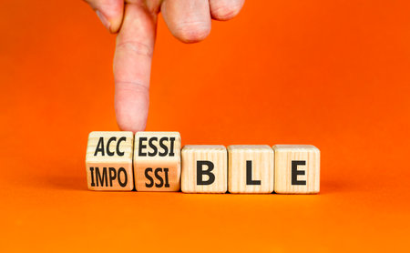 Accessible or impossible symbol. Concept words Accessible or Impossible on beautiful wooden blocks....