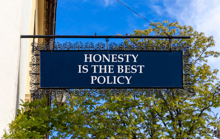 Honesty is the best policy. Concept words Honesty is the best policy on black road sign. Blue sky trees background. Business honesty is the best policy concept. Copy space.の写真素材