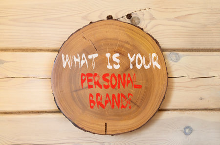 What is your personal brand symbol. Concept words What is your personal brand on beautiful wooden circle. Beautiful wooden wall background. Business what is your personal brand concept. Copy space.の写真素材