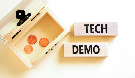 Tech demo symbol. Concept word Tech demo on beautiful wooden blocks. Beautiful white paper...